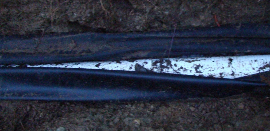 Perforated pipe in ditch with fabric