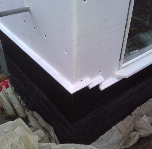 Black waterproofing over two sheets of EPS
